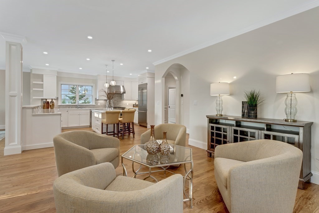 185 Hillside Avenue, Unit 185 Needham, MA 02494 - Photo 9 of 32 a living room with stainless steel appliances a dining table wooden floor and kitchen view