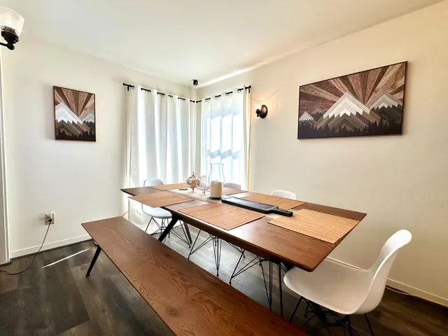 a view of a workspace with furniture and wooden floor