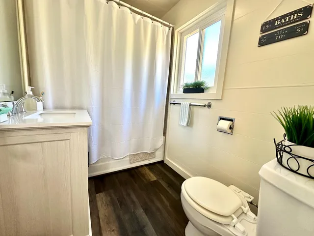 a white toilet sitting next to a bathroom sink