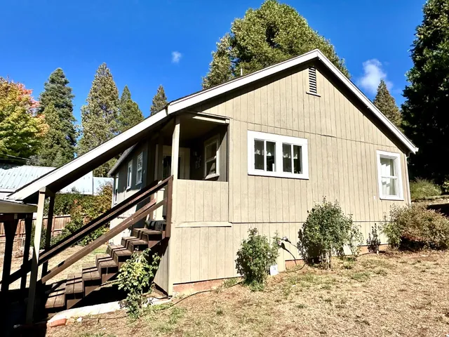 a view of a house with wooden fence
