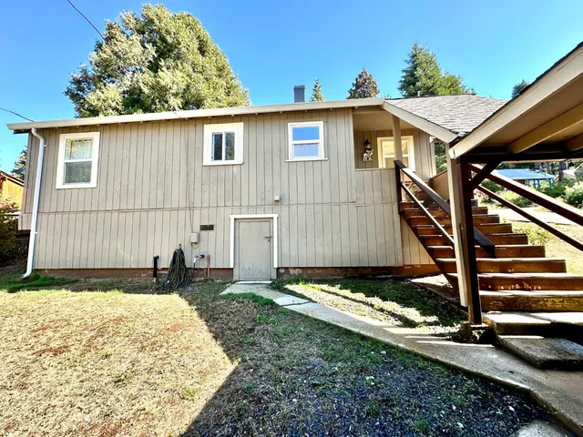 a house view with a backyard space