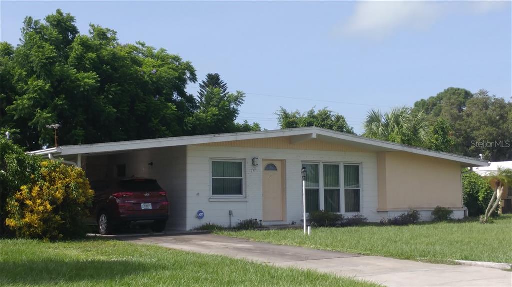 216 Glen Oak Road Venice, FL 34293 - Photo 1 of 1 a front view of a house with a garden
