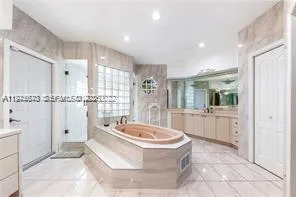 a bathroom with a tub a window and a shower