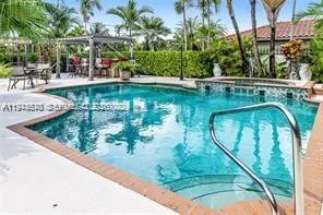 a view of a swimming pool with a patio and plants