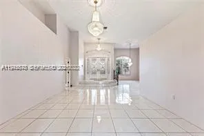 a very nice looking room with a large mirror and cabinets