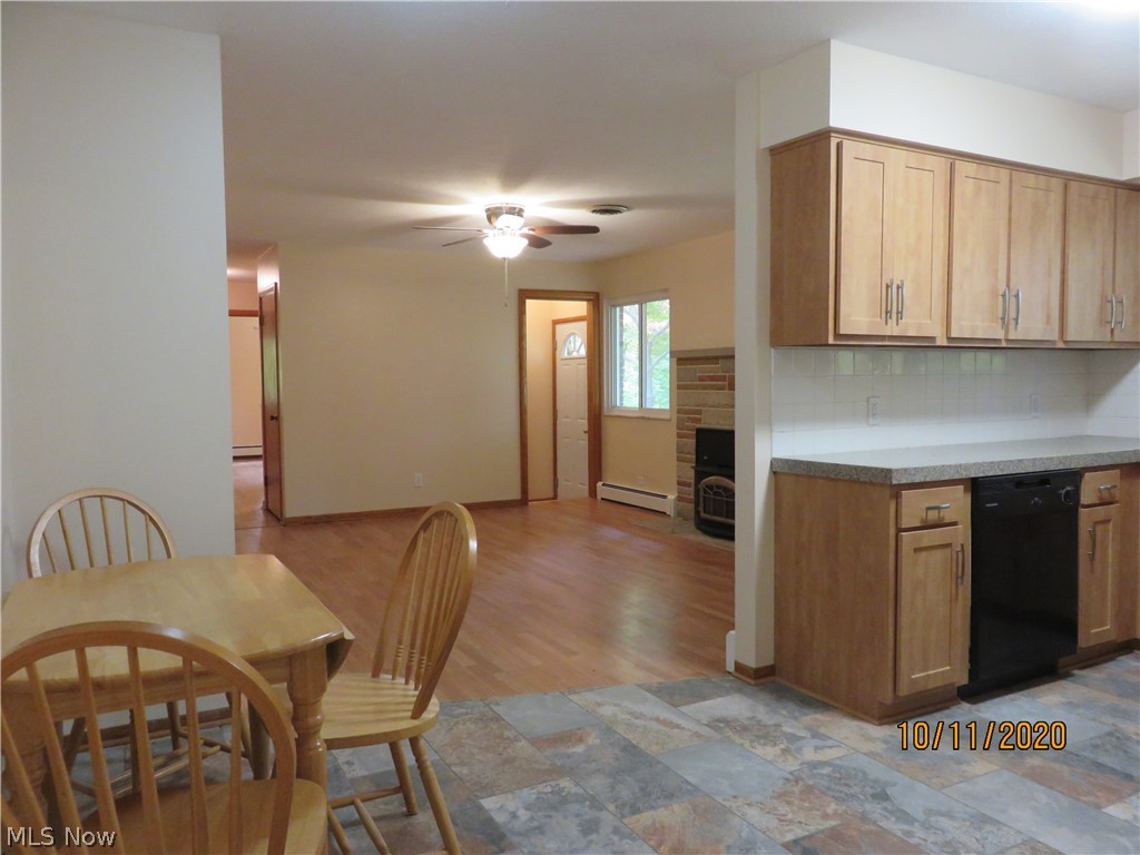 1896 Killian Road Akron, OH 44312 - Photo 8 of 23 Kitchen to Family Room with woodburner and new laminate flooring. New stone ceramic floors and cabinets.