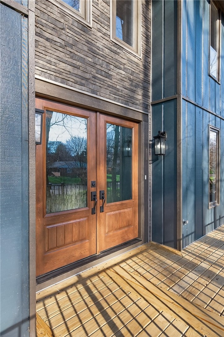 4747 Fawnwood Road Dayton, OH 45429 - Photo 6 of 58 This inviting entrance features elegant double doors, complementing the natural stone and siding exterior.