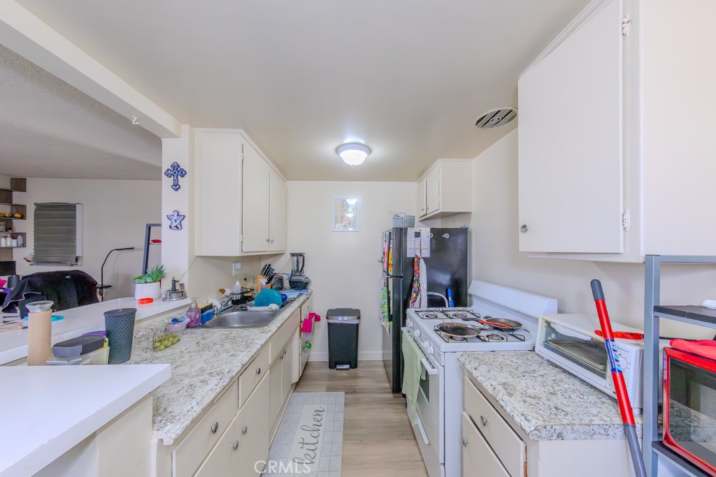 906 South Fann Street Anaheim, CA 92804 - Photo 9 of 27 a kitchen that has a lot of cabinets a sink and a stove in it