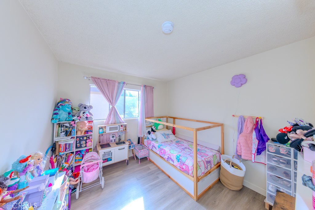 906 South Fann Street Anaheim, CA 92804 - Photo 12 of 27 a bedroom with a bed and a window