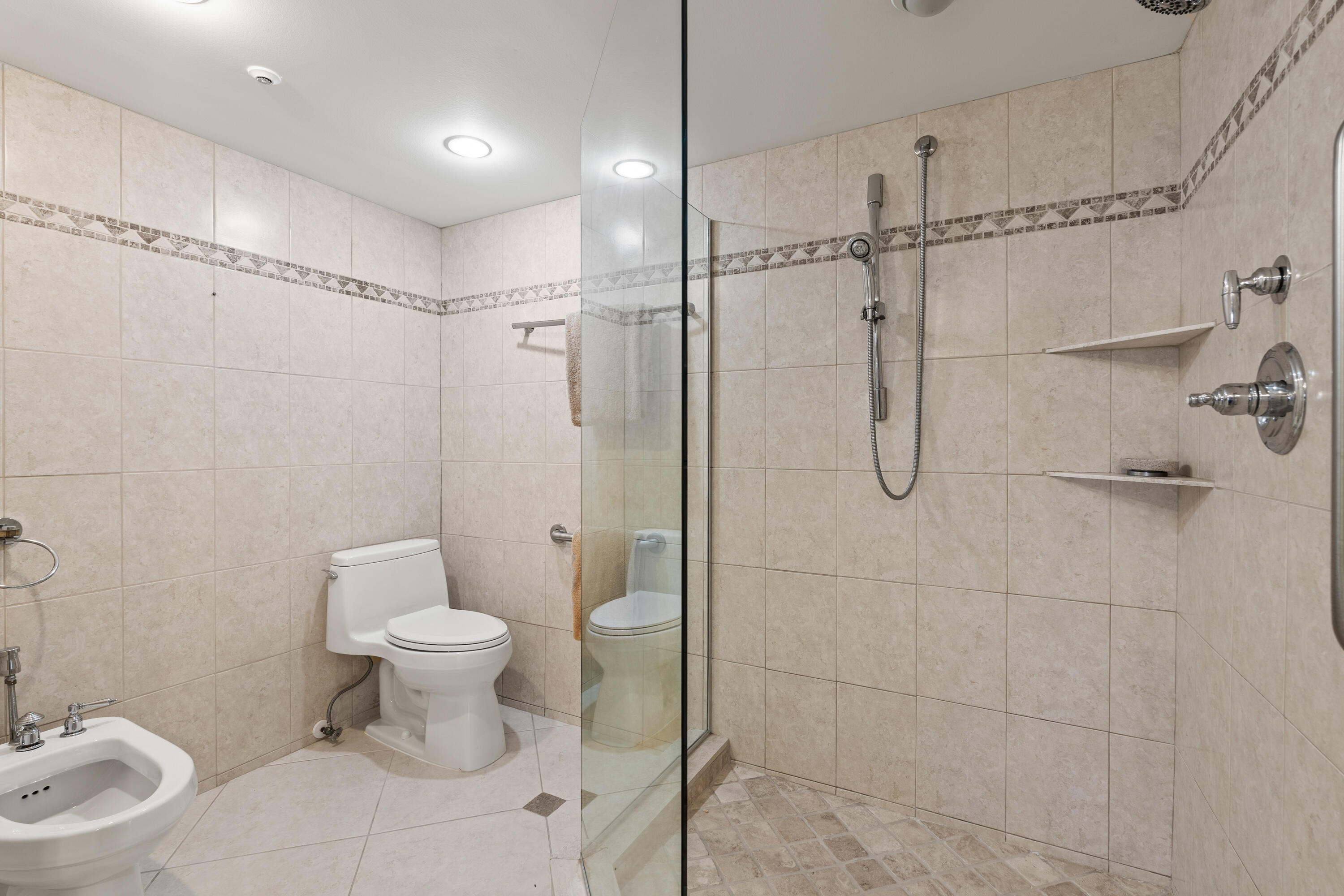 16940 Bay Street, Unit N504 Jupiter, FL 33477 - Photo 18 of 33 a bathroom with a toilet sink and shower