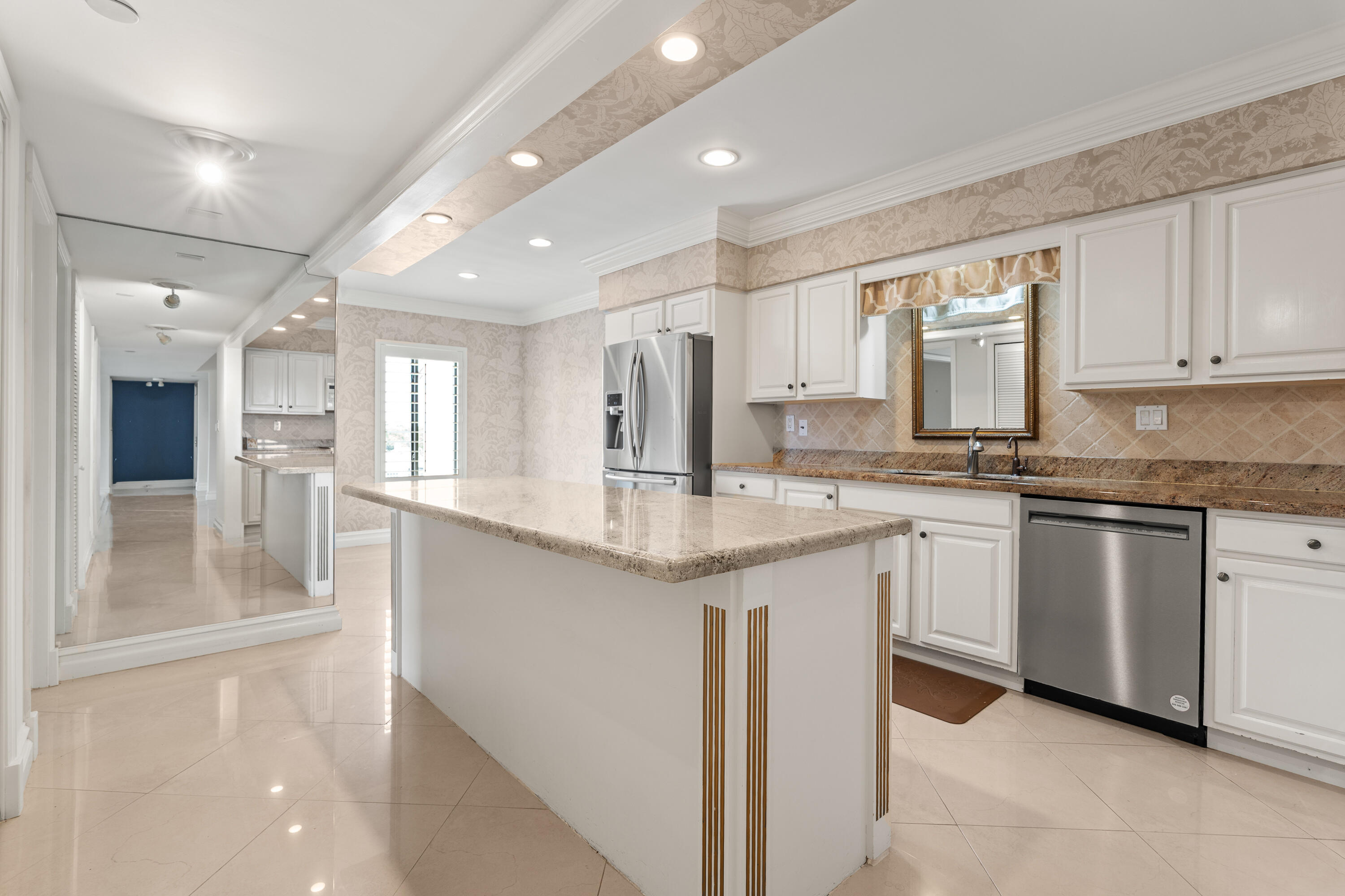 16940 Bay Street, Unit N504 Jupiter, FL 33477 - Photo 19 of 33 a kitchen with granite countertop a sink and cabinets