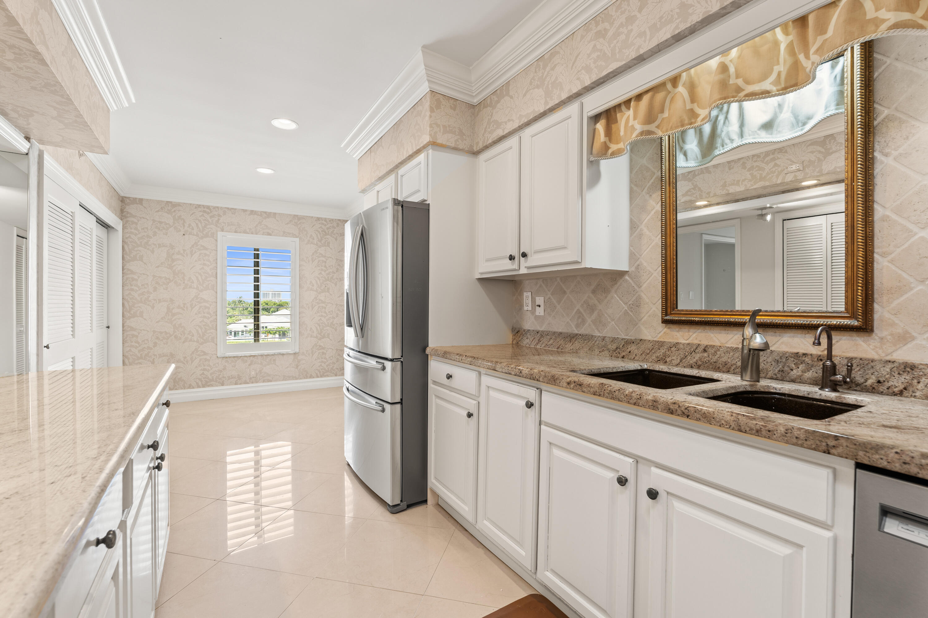 16940 Bay Street, Unit N504 Jupiter, FL 33477 - Photo 22 of 33 a kitchen with a sink stove and cabinets