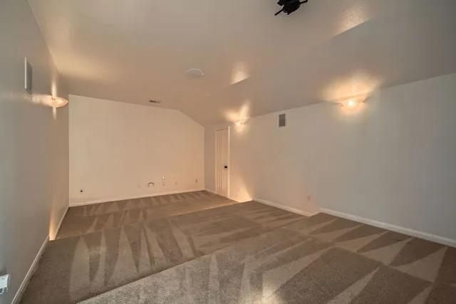 a view of a balcony with wooden floor and fence