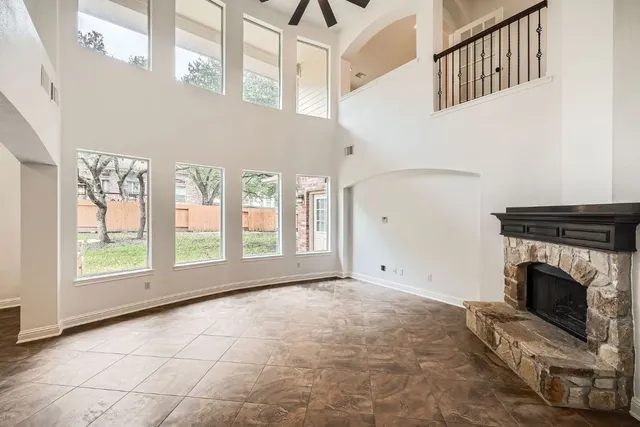 a view of an empty room with a fireplace and a window