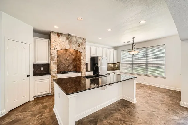 a view of kitchen island a sink and living room