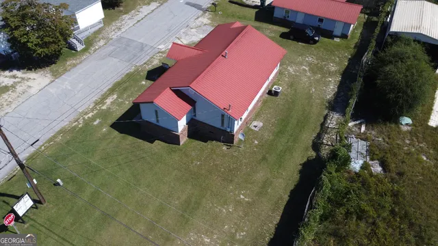 a aerial view of a house with a yard