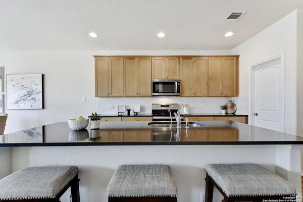 a kitchen with a sink cabinets and window