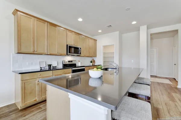 a kitchen with a sink dishwasher stove and microwave