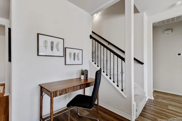 a view of a hallway with paintings on the wall