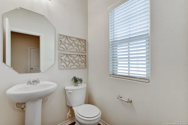 a view of a hallway with wooden floor and entryway