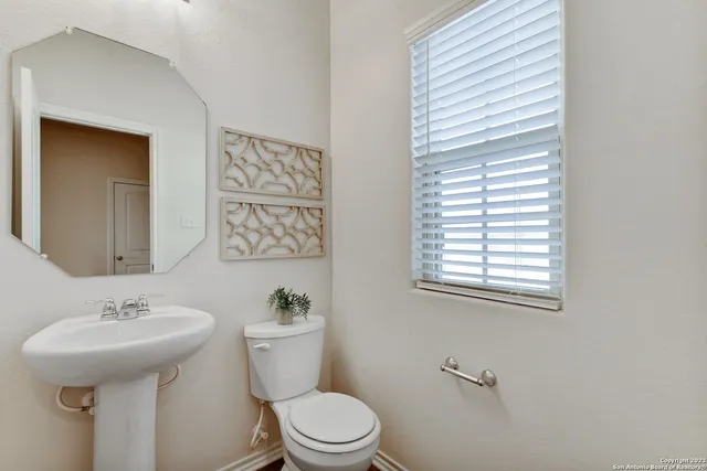 a view of a hallway with wooden floor and entryway