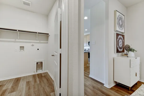 a bedroom with a bed a lamp and a large mirror