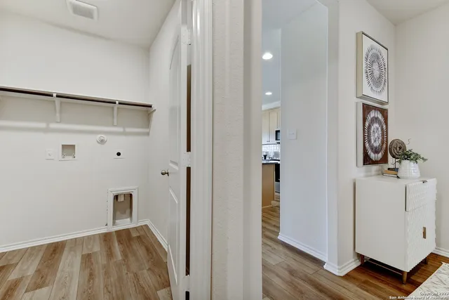 a bedroom with a bed a lamp and a large mirror