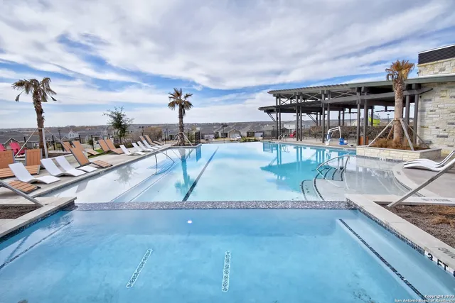 a view of a swimming pool with lounge chairs