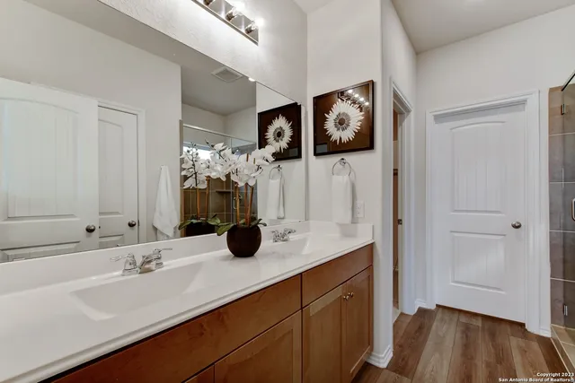 a bathroom with a shower and a glass door