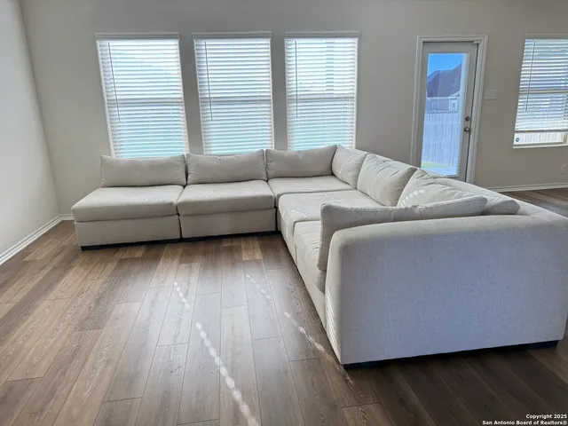 a living room with furniture and windows