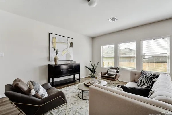 a living room with furniture and a floor to ceiling window
