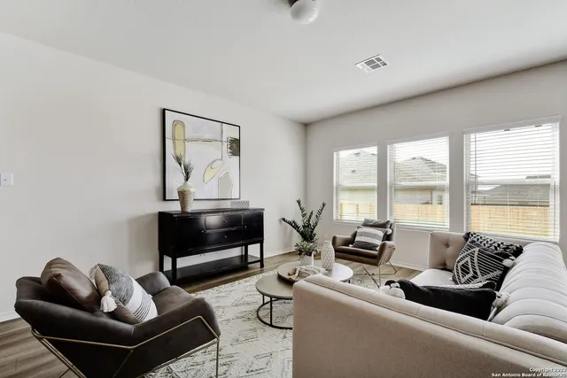 a living room with furniture and a floor to ceiling window