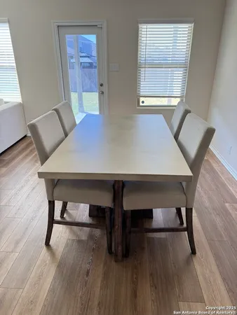 a view of a dining room with furniture and wooden floor