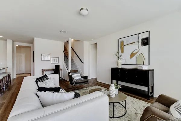 a living room with furniture a flat screen tv and a fireplace