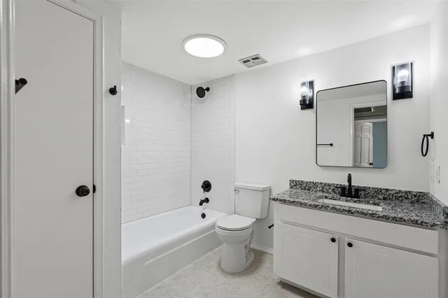 a kitchen with white cabinets and appliances
