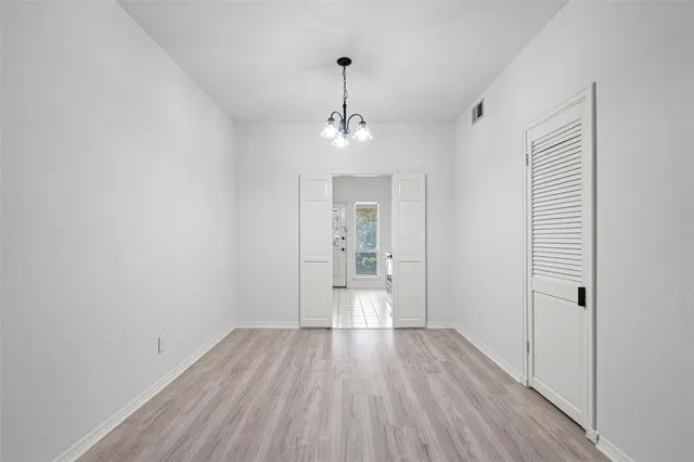 a view of a room with wooden floor staircase and a bathroom