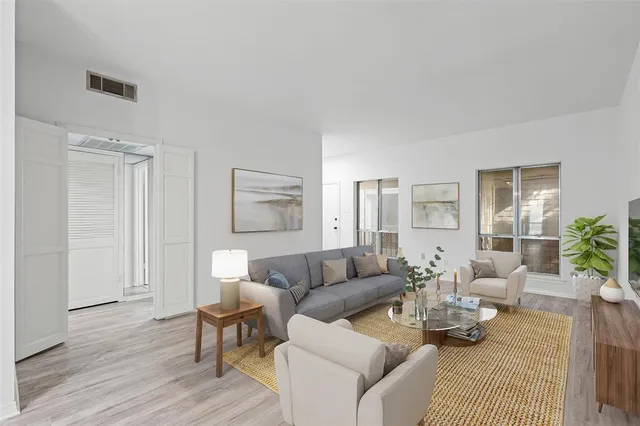 a view of a room with wooden floor and white walls