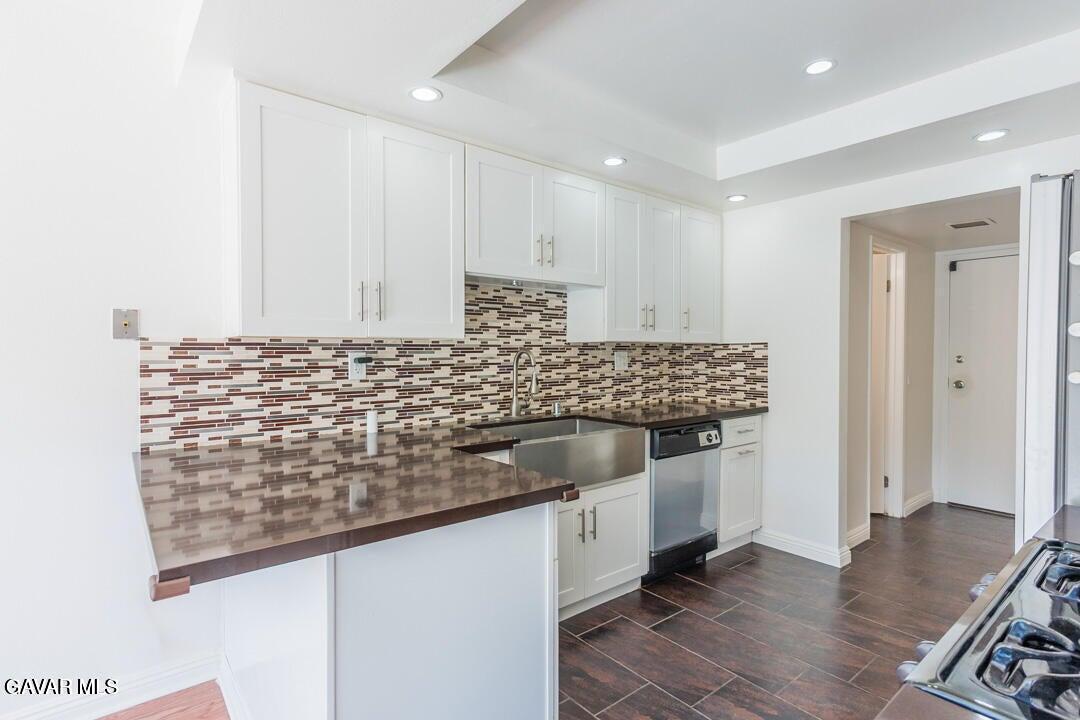18452 Lemarsh Street, Unit 48 Northridge, CA 91325 - Photo 13 of 45 a kitchen with granite countertop white cabinets and white appliances