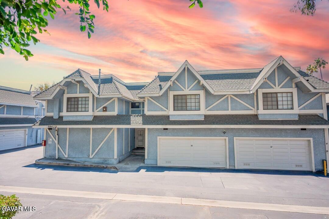 18452 Lemarsh Street, Unit 48 Northridge, CA 91325 - Photo 2 of 45 a view of a white house with large windows and a palm tree