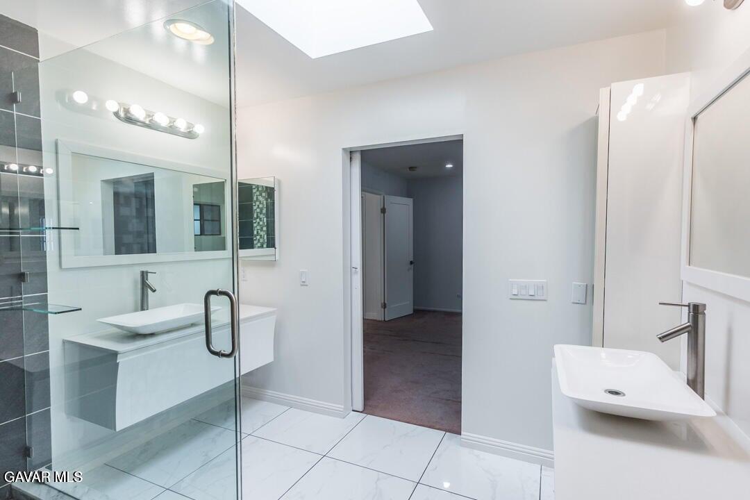 18452 Lemarsh Street, Unit 48 Northridge, CA 91325 - Photo 33 of 45 a bathroom with a sink and mirror