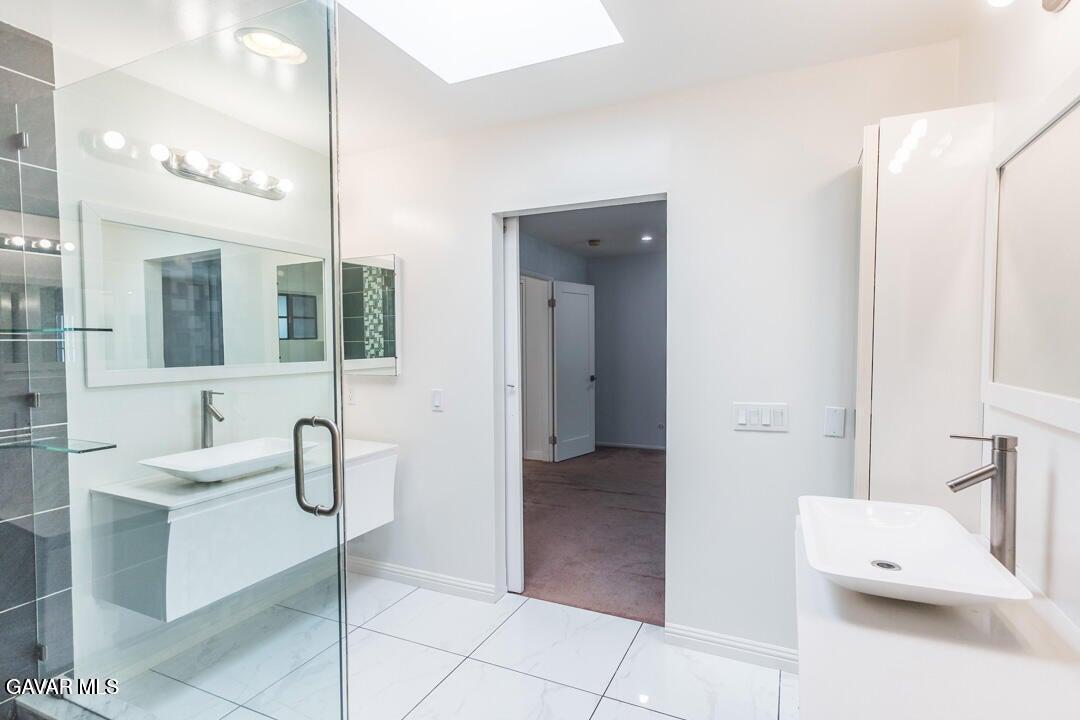 18452 Lemarsh Street, Unit 48 Northridge, CA 91325 - Photo 34 of 45 a bathroom with a sink and mirror
