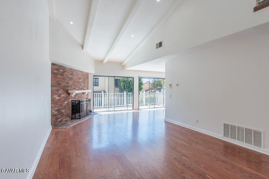 18452 Lemarsh Street, Unit 48 Northridge, CA 91325 - Photo 5 of 45 an empty room with wooden floor and fireplace