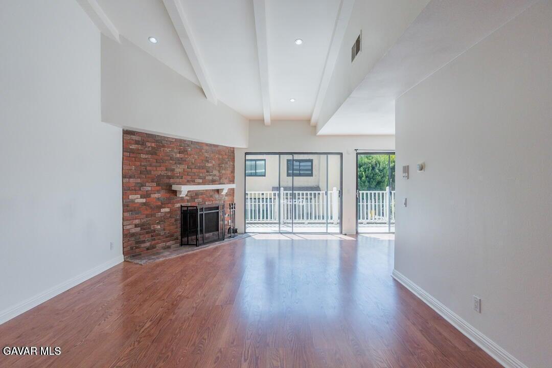 18452 Lemarsh Street, Unit 48 Northridge, CA 91325 - Photo 8 of 45 wooden floor in an empty room with a fireplace