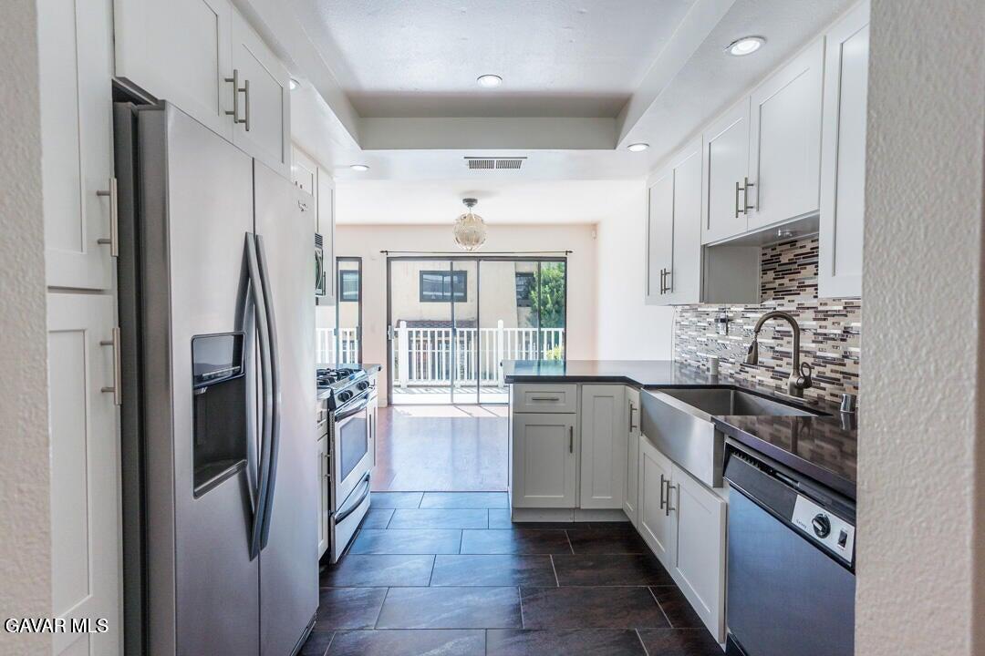 18452 Lemarsh Street, Unit 48 Northridge, CA 91325 - Photo 10 of 45 a kitchen with stainless steel appliances granite countertop a refrigerator and a sink