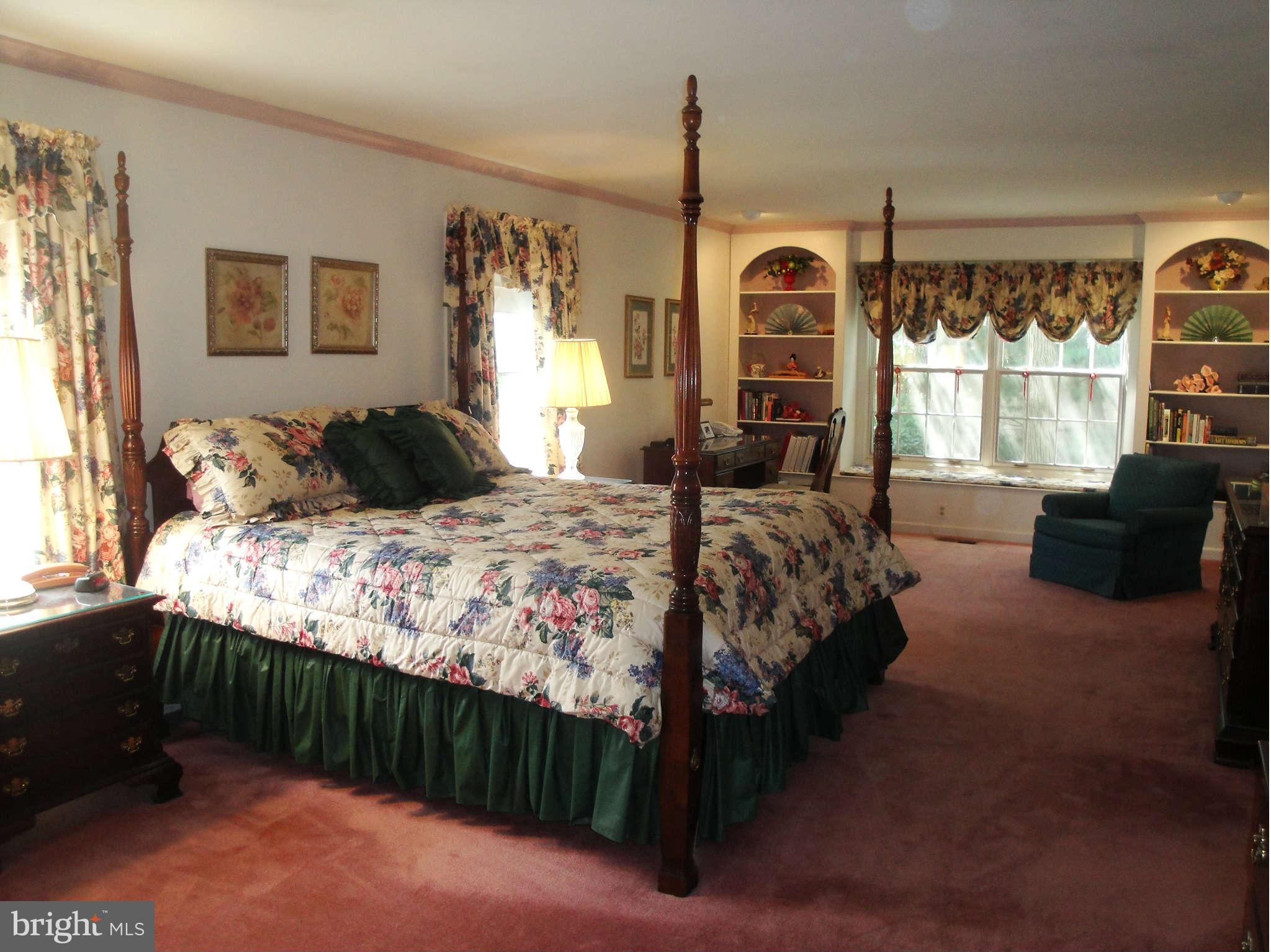 6406 Darwin Road Laurel, MD 20707 - Photo 12 of 22 a bedroom with a bed and a dresser next to a window