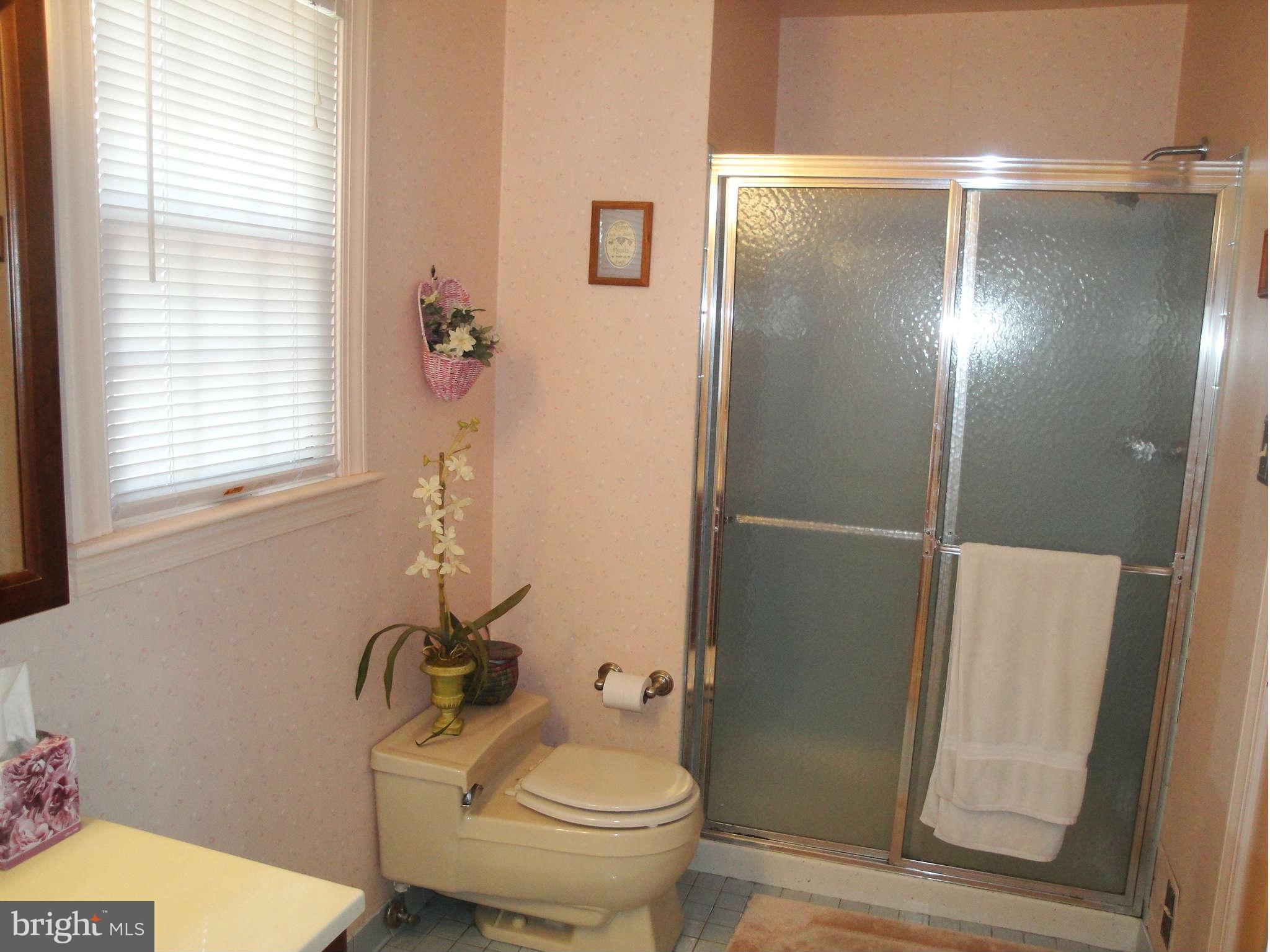 6406 Darwin Road Laurel, MD 20707 - Photo 15 of 22 a bathroom with a toilet and a shower