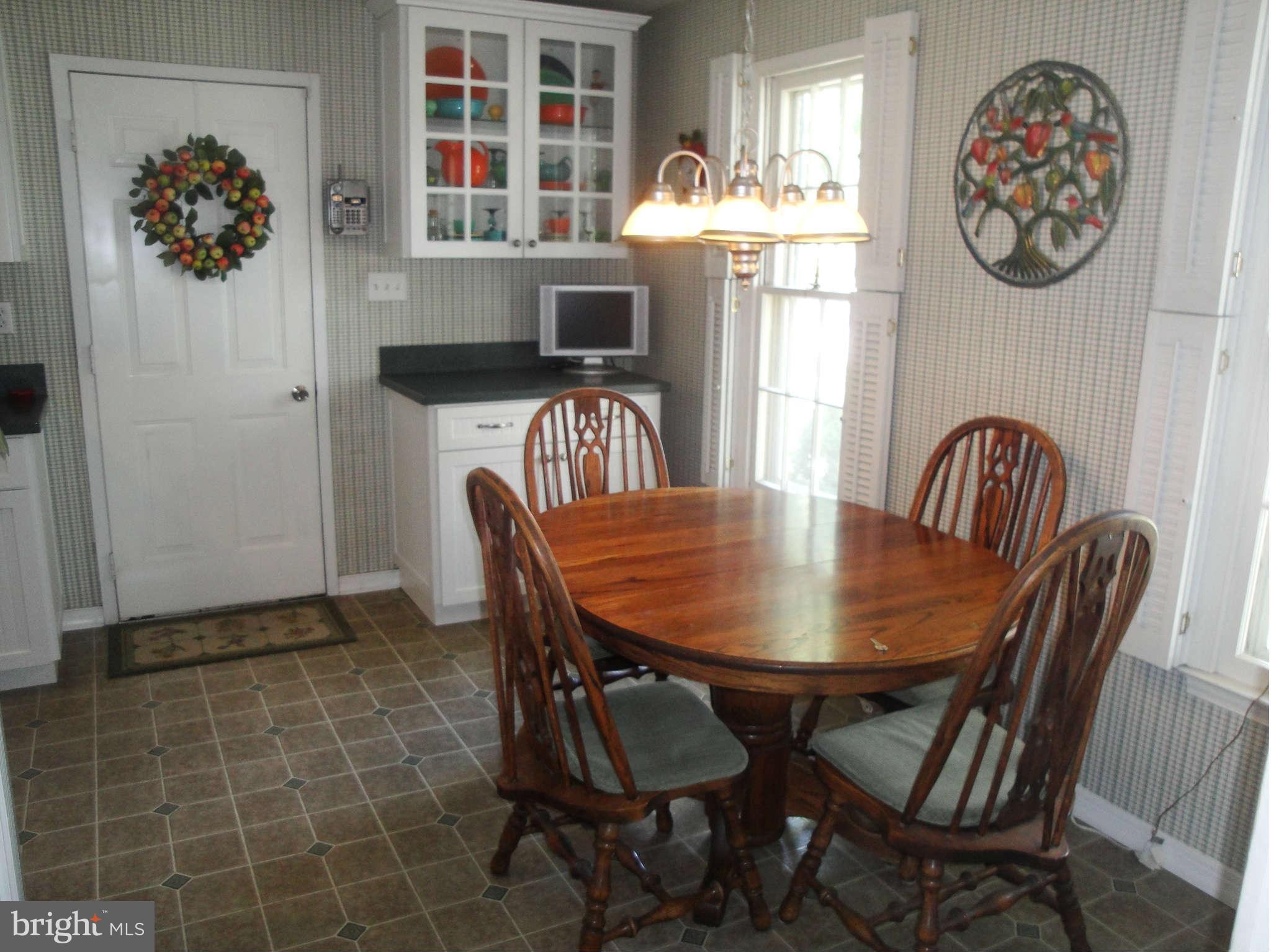 6406 Darwin Road Laurel, MD 20707 - Photo 4 of 22 a view of a dining room with furniture and chandelier