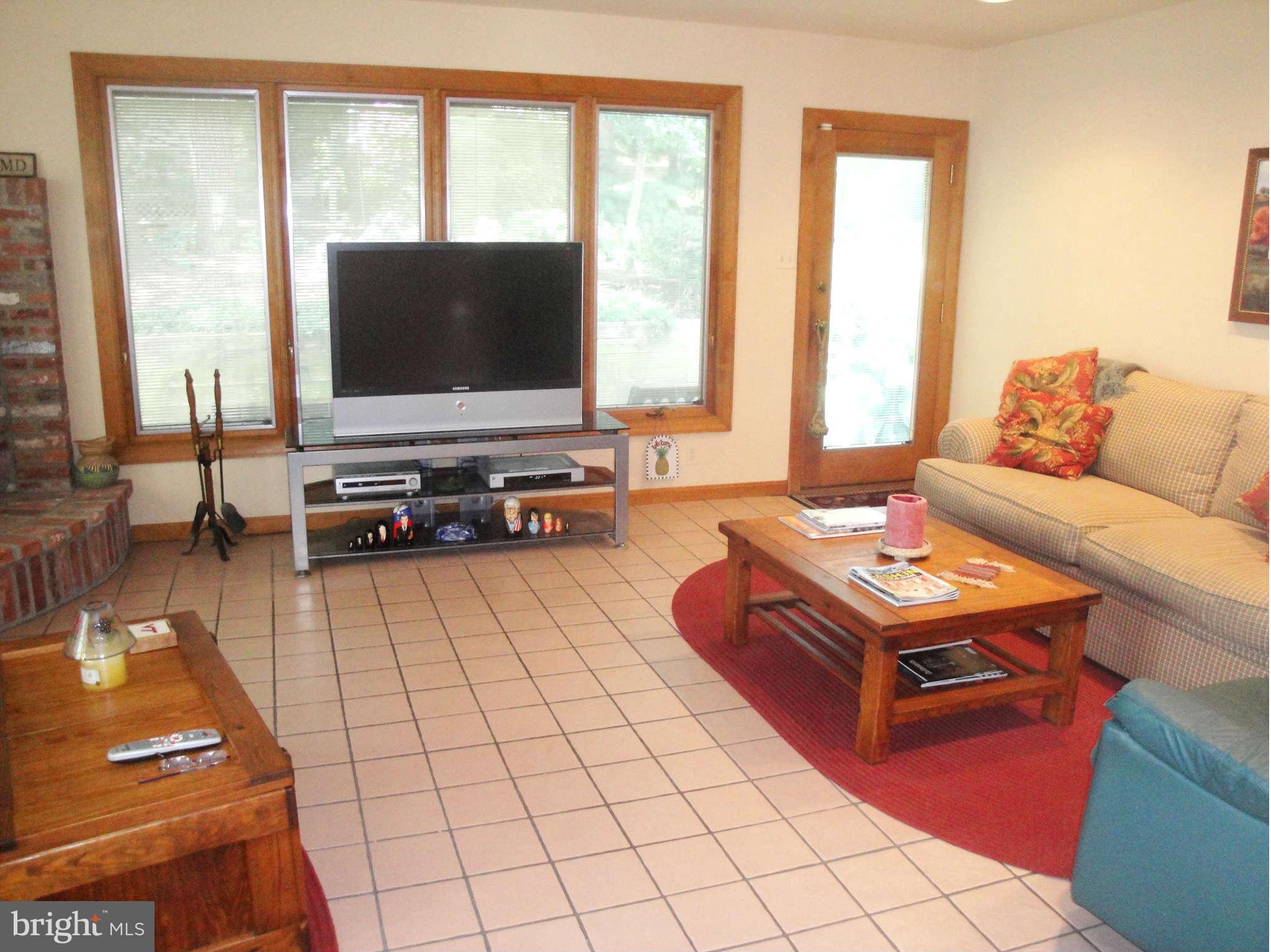 6406 Darwin Road Laurel, MD 20707 - Photo 7 of 22 a living room with furniture and a flat screen tv