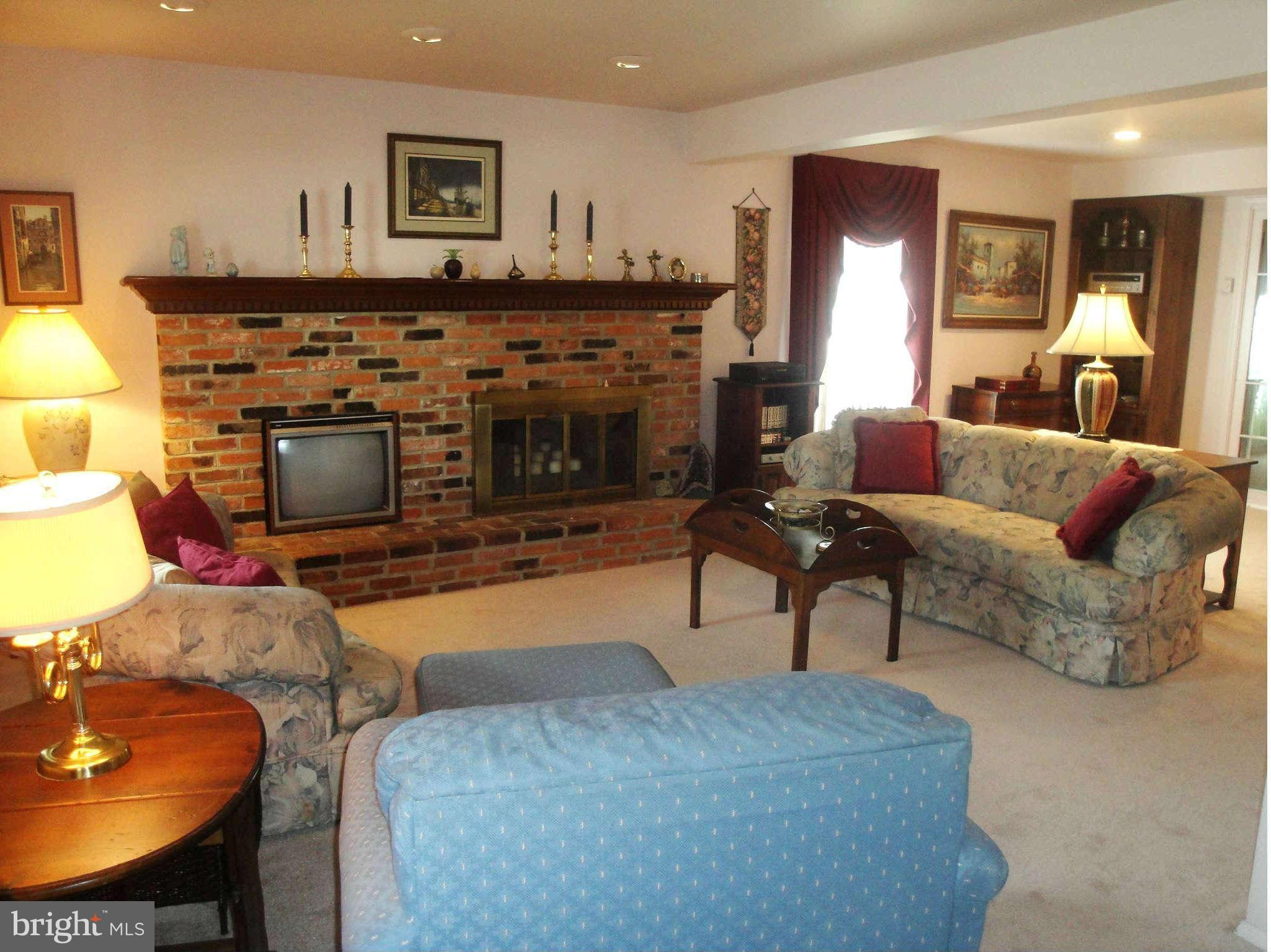 6406 Darwin Road Laurel, MD 20707 - Photo 8 of 22 a living room with furniture and a fireplace