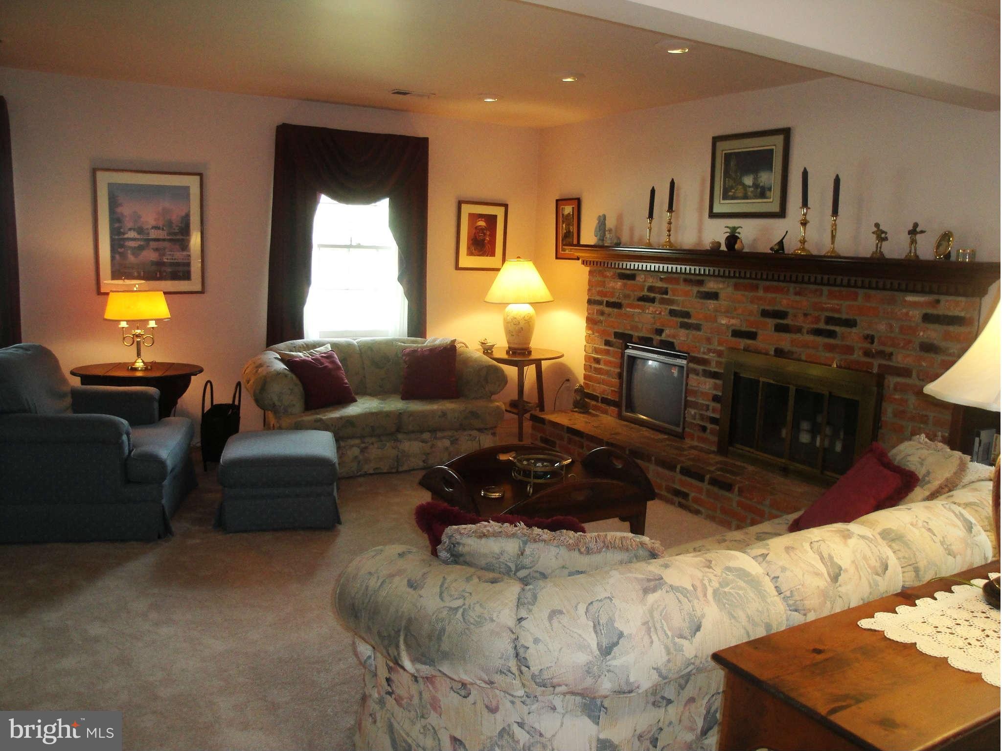 6406 Darwin Road Laurel, MD 20707 - Photo 9 of 22 a living room with furniture and a flat screen tv